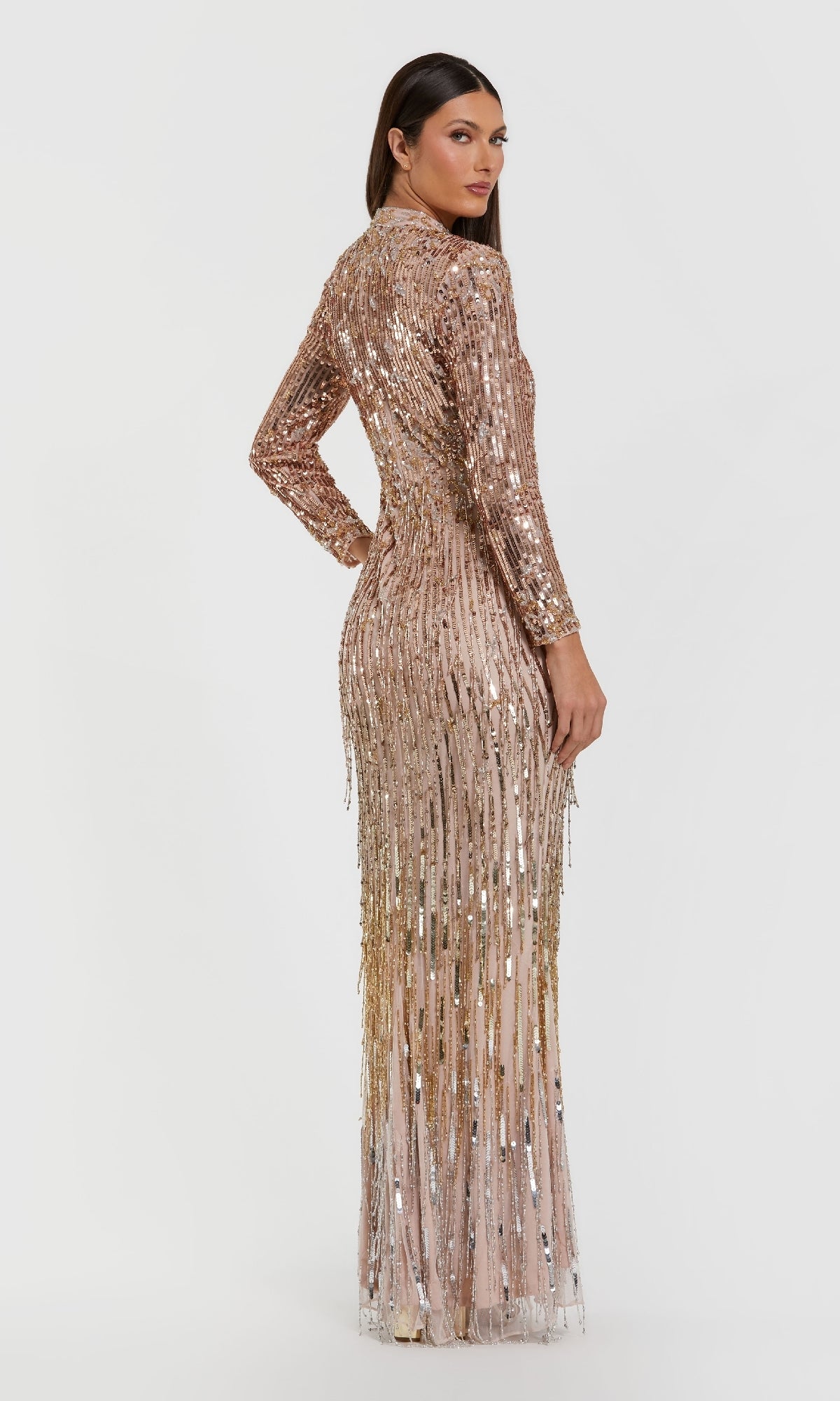 Woman wearing a sparkly gold dress on a white background